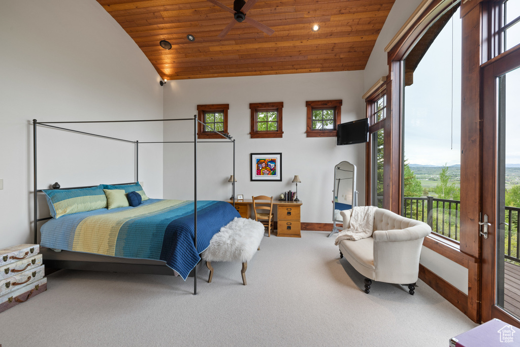 Bedroom featuring wooden ceiling, lofted ceiling, carpet floors, multiple windows, and a desk