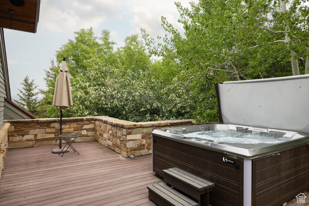 Wooden terrace featuring a hot tub
