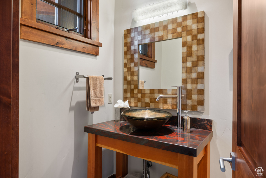 Bathroom with backsplash and a sink