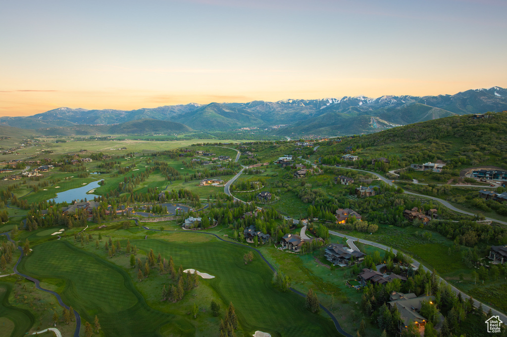 Aerial view at dusk of a water and mountain view and golf course view