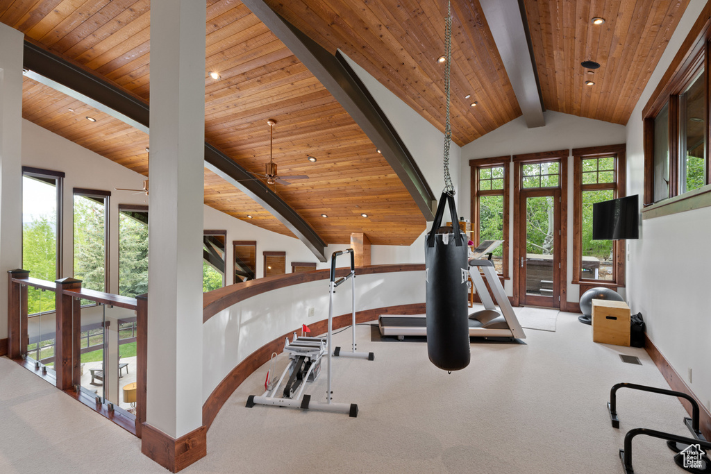Exercise area with lofted ceiling, wood ceiling, baseboards, recessed lighting, and carpet flooring