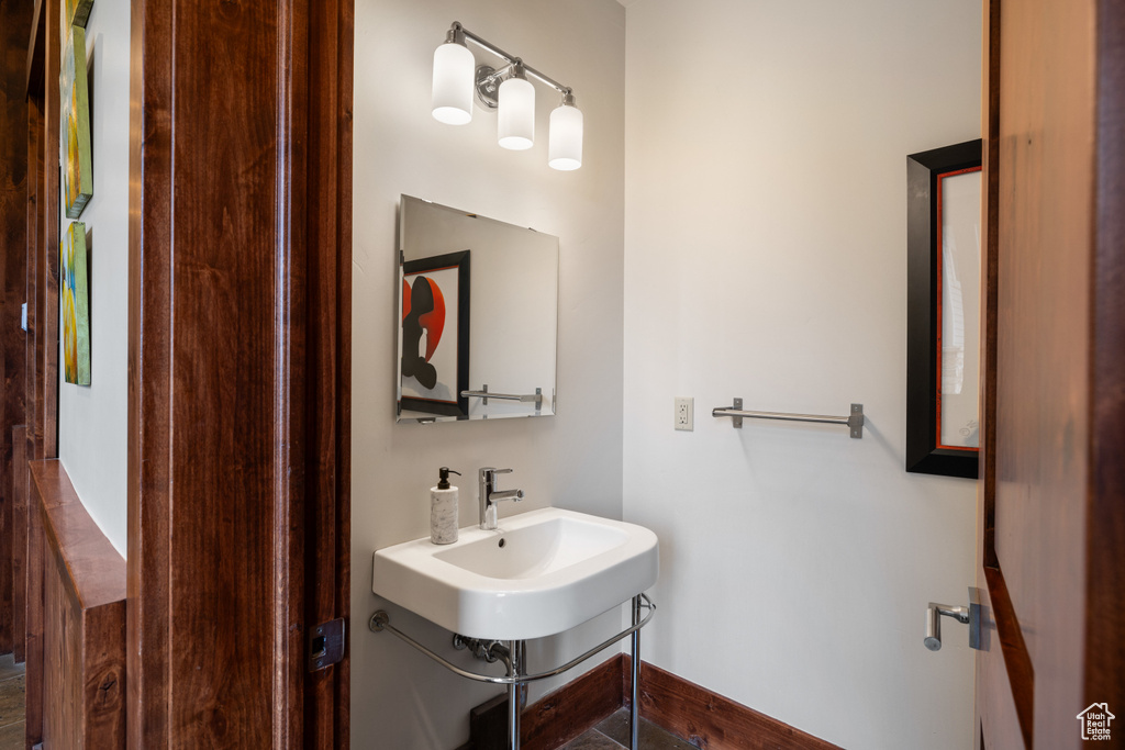 Bathroom with a sink and baseboards