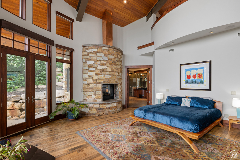 Bedroom featuring french doors, access to exterior, high vaulted ceiling, wood finished floors, and wooden ceiling