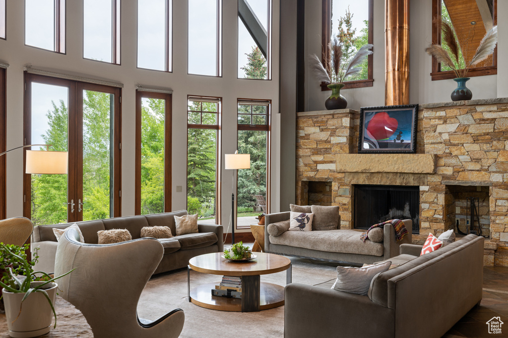 Living room featuring a fireplace and a towering ceiling