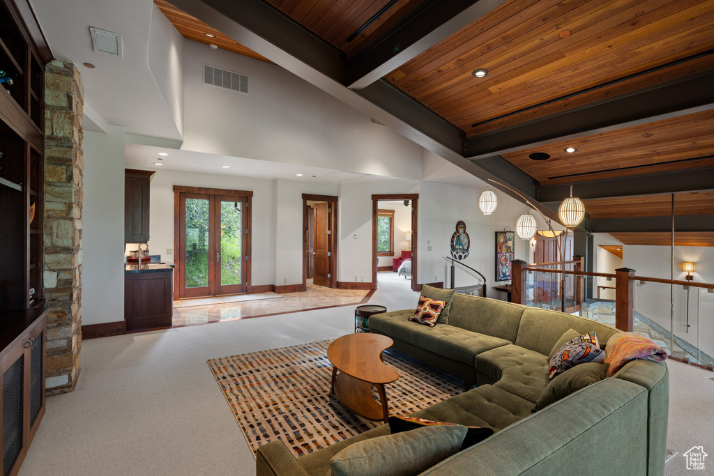 Living room featuring light carpet, wooden ceiling with exposed beams, recessed lighting, and baseboards