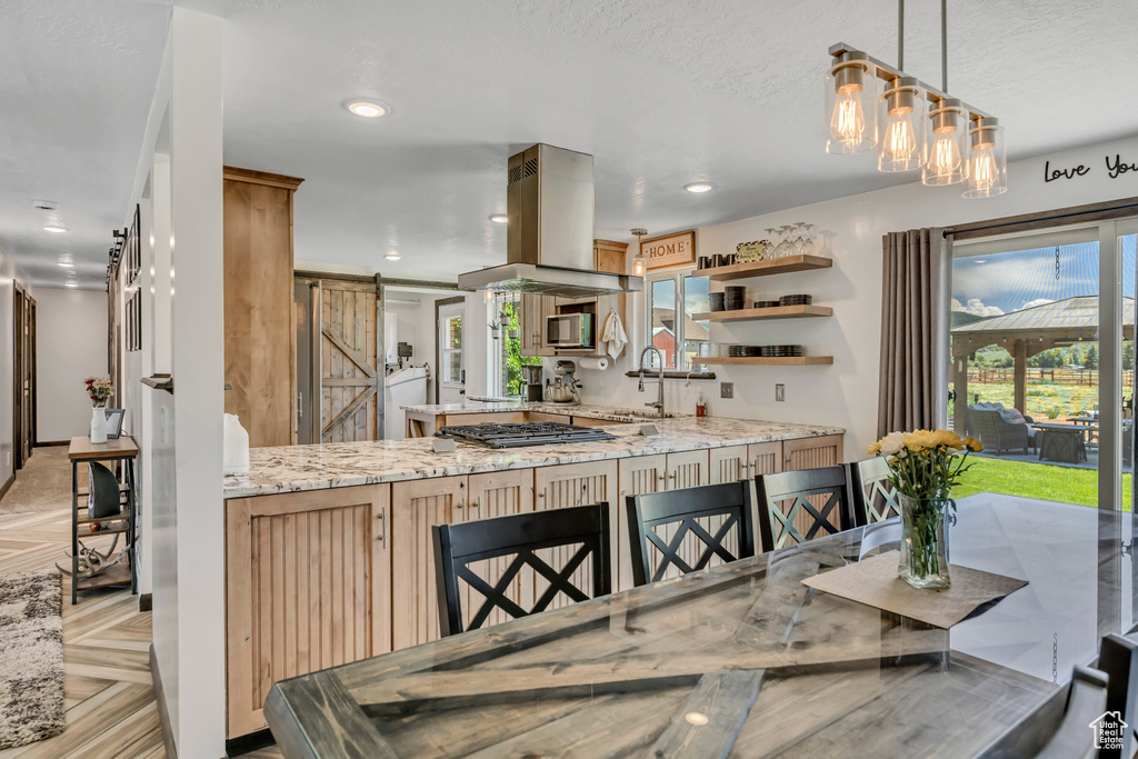 Dining area with a barn door and recessed lighting