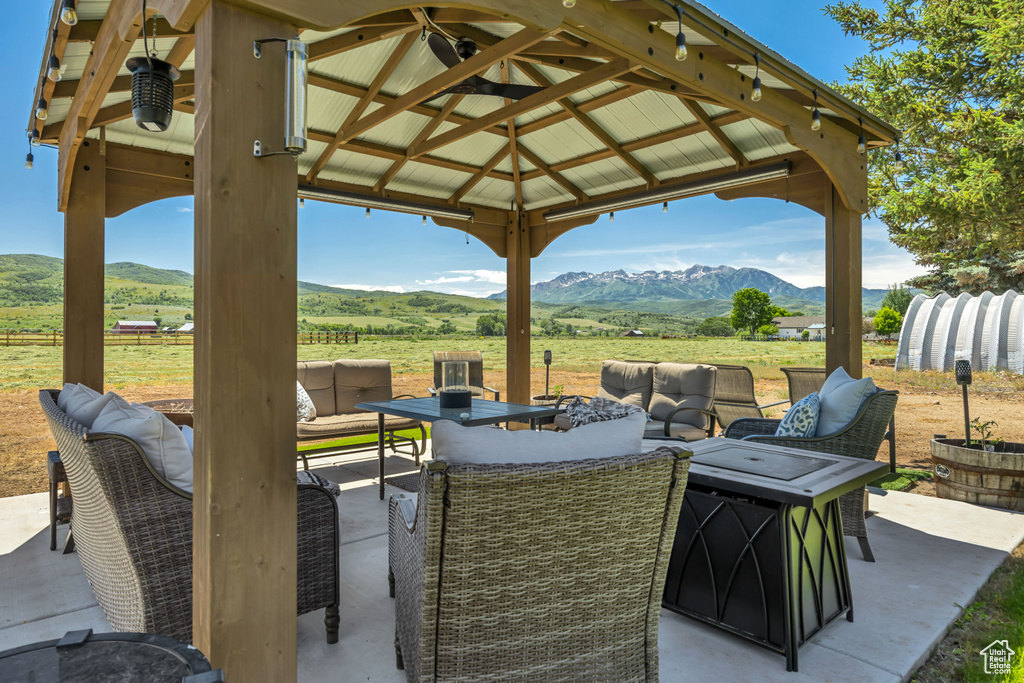 View of patio / terrace featuring outdoor lounge area, a mountain view, and a rural view