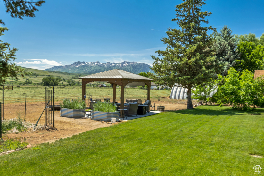 View of yard with a gazebo, a mountain view, a garden, and an outdoor living space
