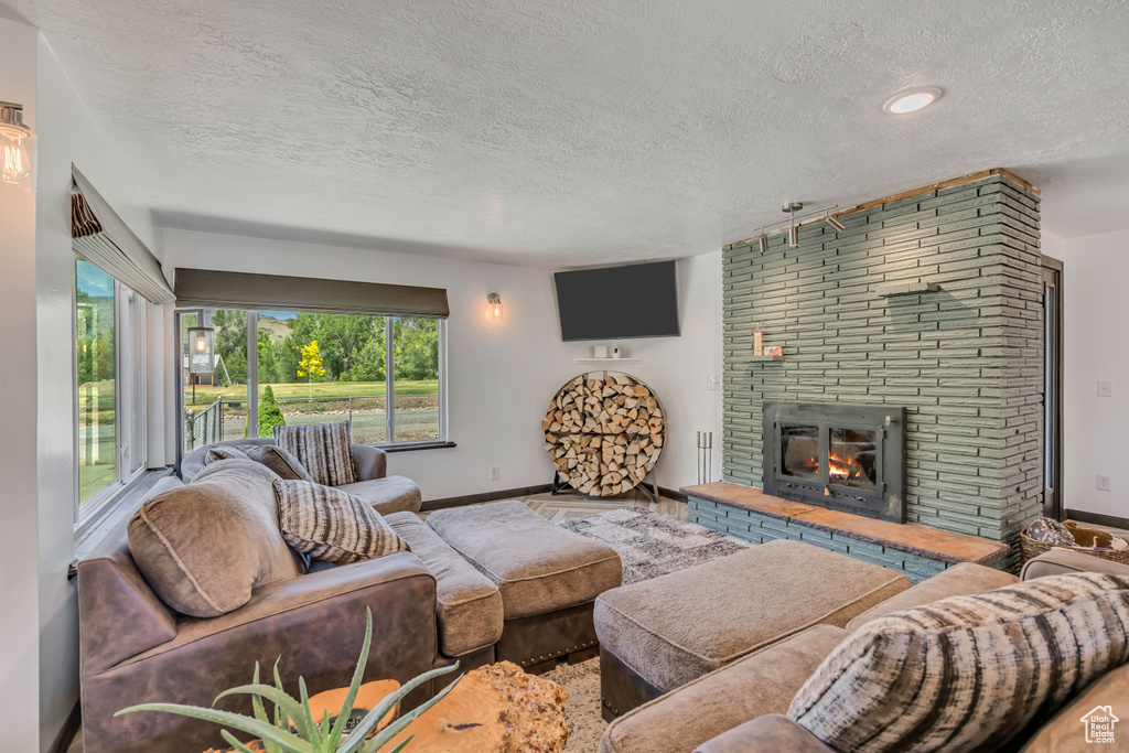 Living room with a textured ceiling and a fireplace