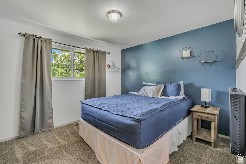 Carpeted bedroom featuring baseboards