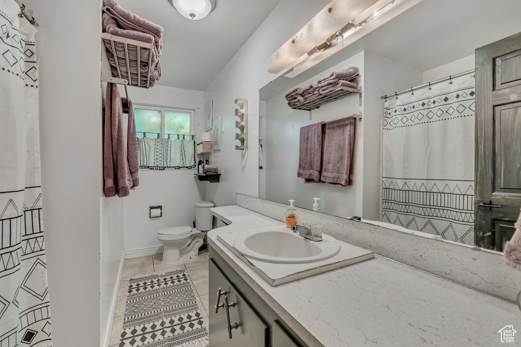 Full bathroom featuring vanity, tile patterned flooring, and a shower with shower curtain