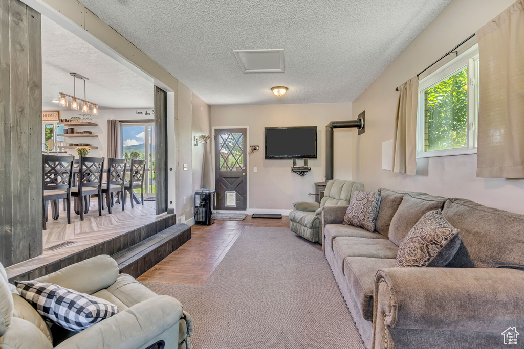 Living area with a textured ceiling and carpet