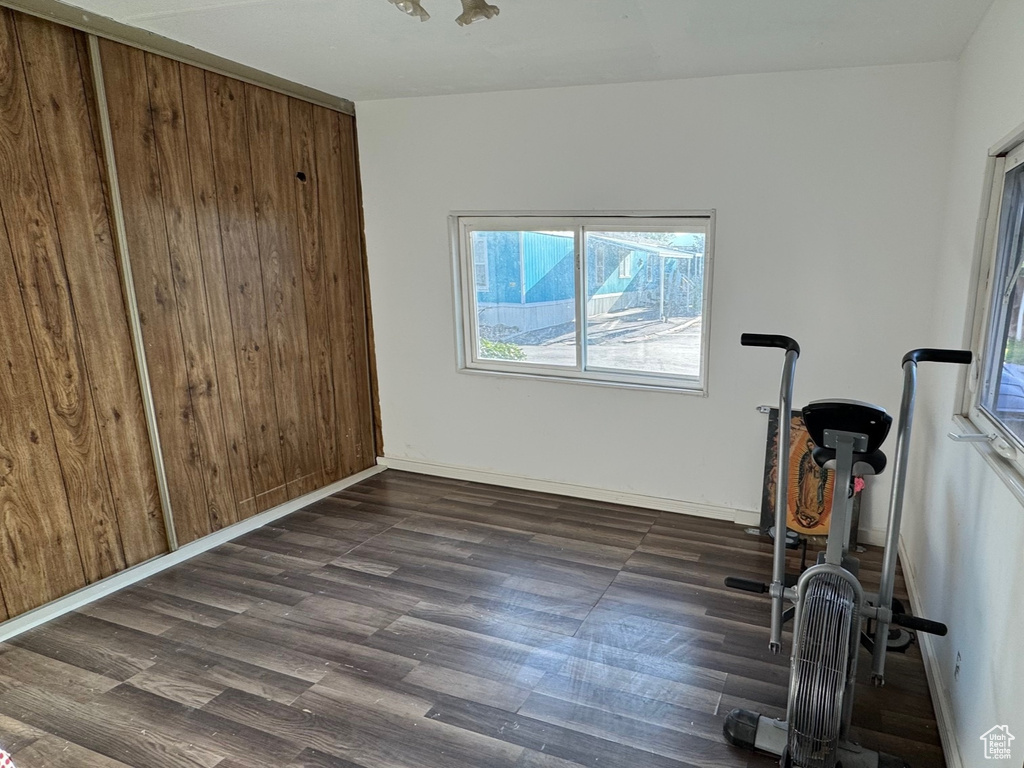 Unfurnished bedroom with wood finished floors and baseboards