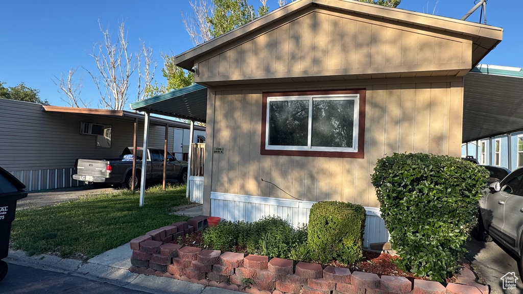 View of side of property featuring a lawn