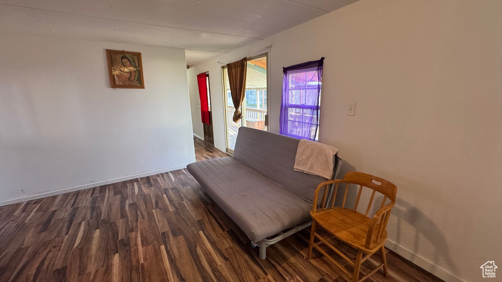 Sitting room featuring dark wood-style floors and baseboards