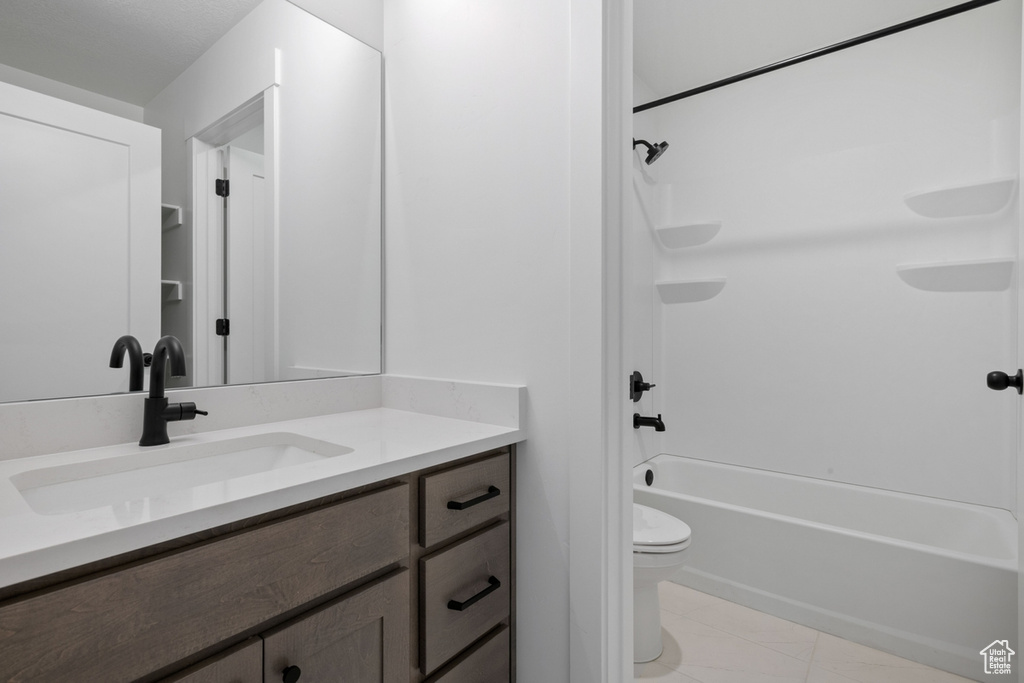 Full bath featuring vanity,  shower combination, and marble finish floors