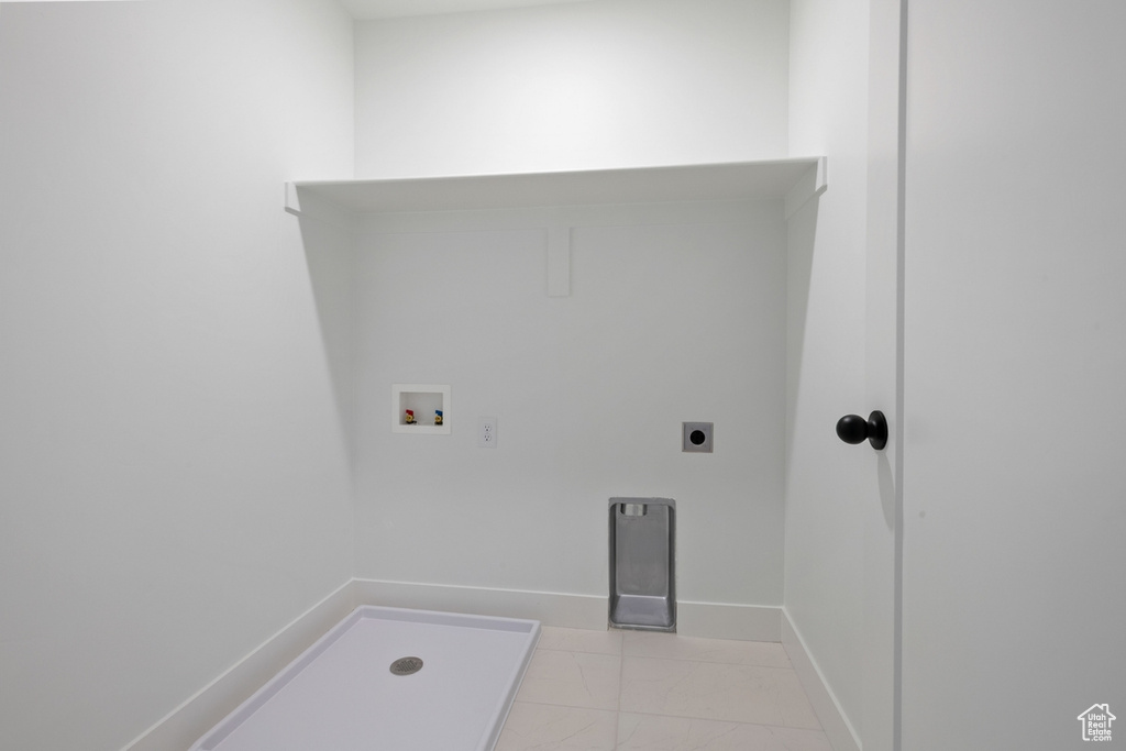 Laundry area with hookup for a washing machine, light marble finish floors, and hookup for an electric dryer