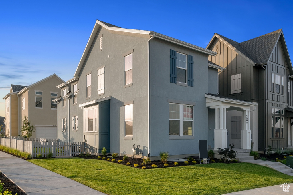 View of front of property featuring board and batten siding and stucco siding
