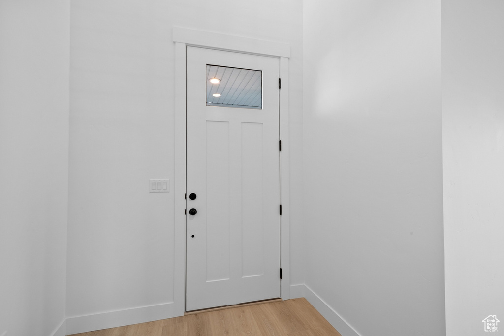 Entryway with light wood-type flooring and baseboards