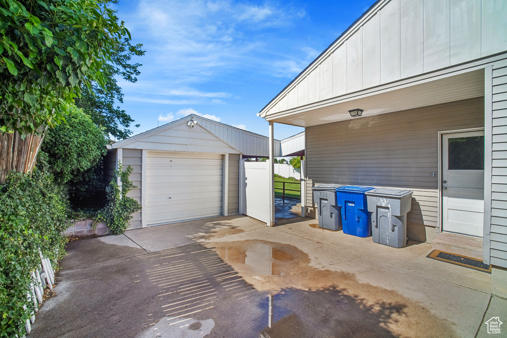 Detached garage featuring concrete driveway