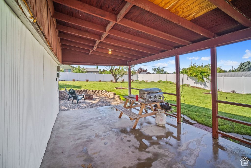 View of patio featuring a fire pit and grilling area