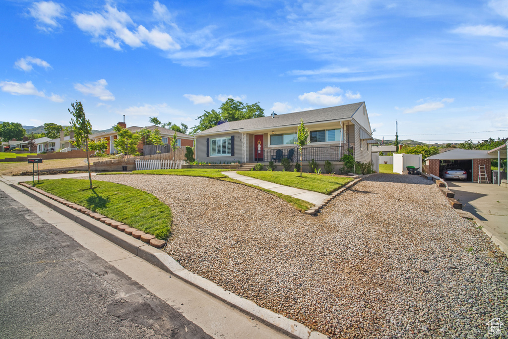 View of front of home with gravel driveway