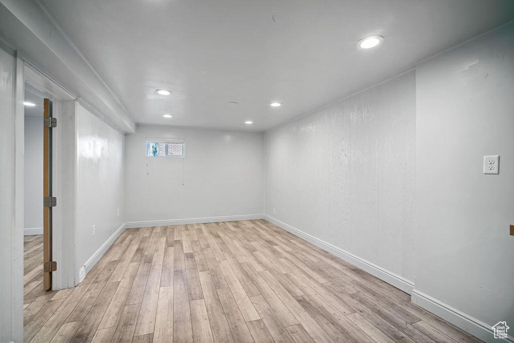 Below grade area with light wood-type flooring, recessed lighting, and baseboards