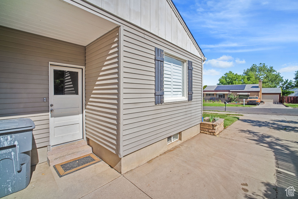View of exterior entry featuring board and batten siding