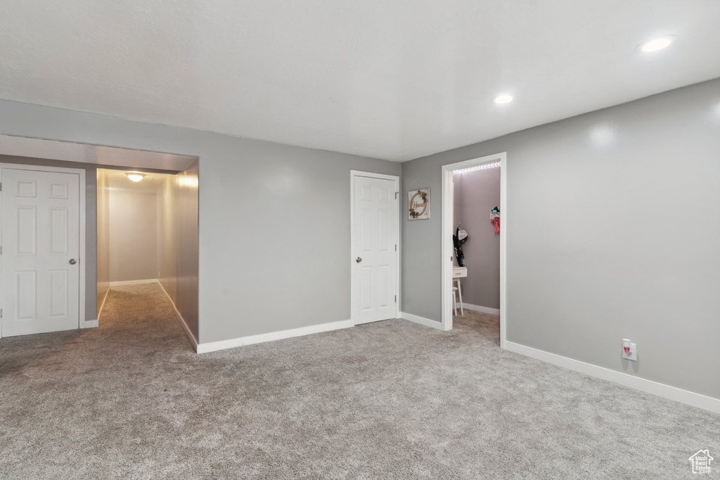 Unfurnished bedroom featuring carpet flooring, a closet, recessed lighting, and a spacious closet