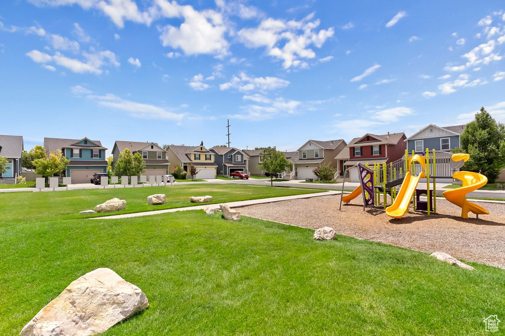 Community jungle gym featuring a residential view and a yard