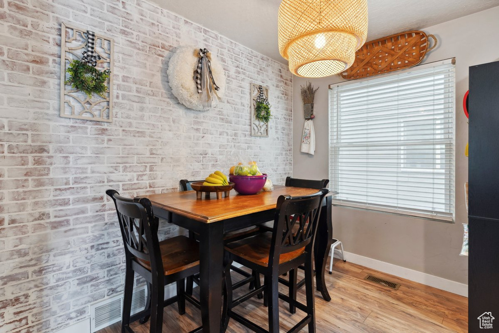 Dining room with baseboards and light wood-type flooring
