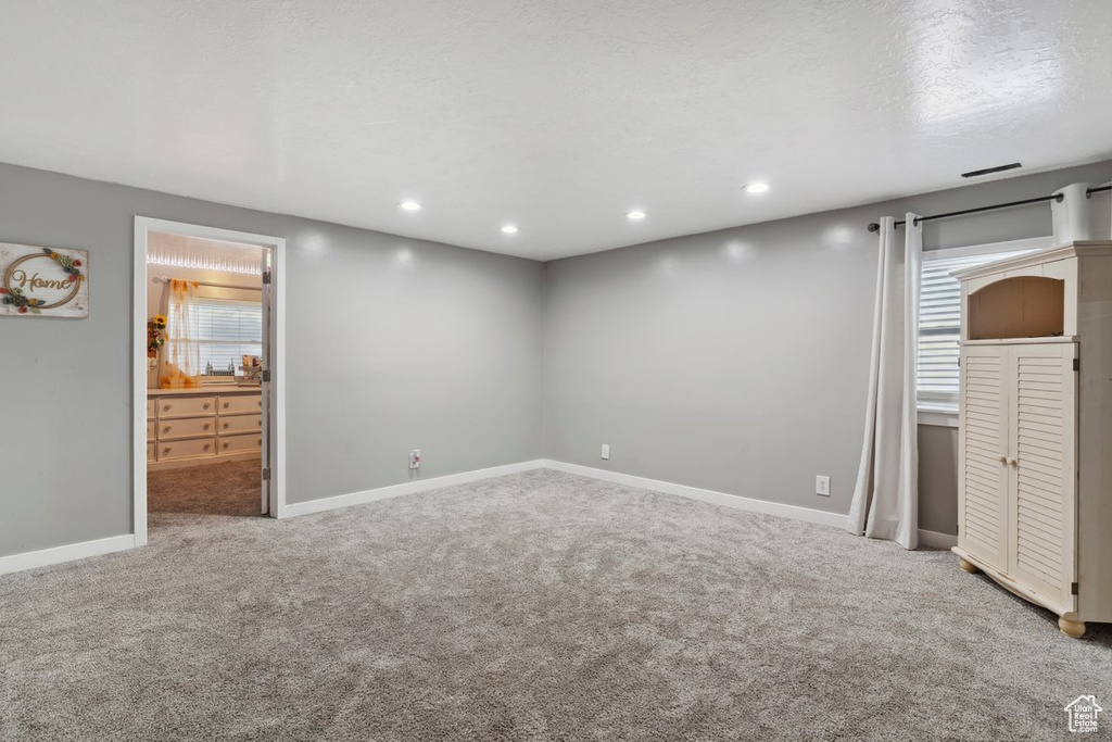 Unfurnished bedroom with carpet floors, recessed lighting, and connected bathroom