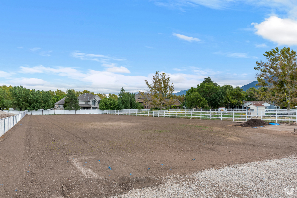 View of yard featuring an enclosed riding area and a mountain view