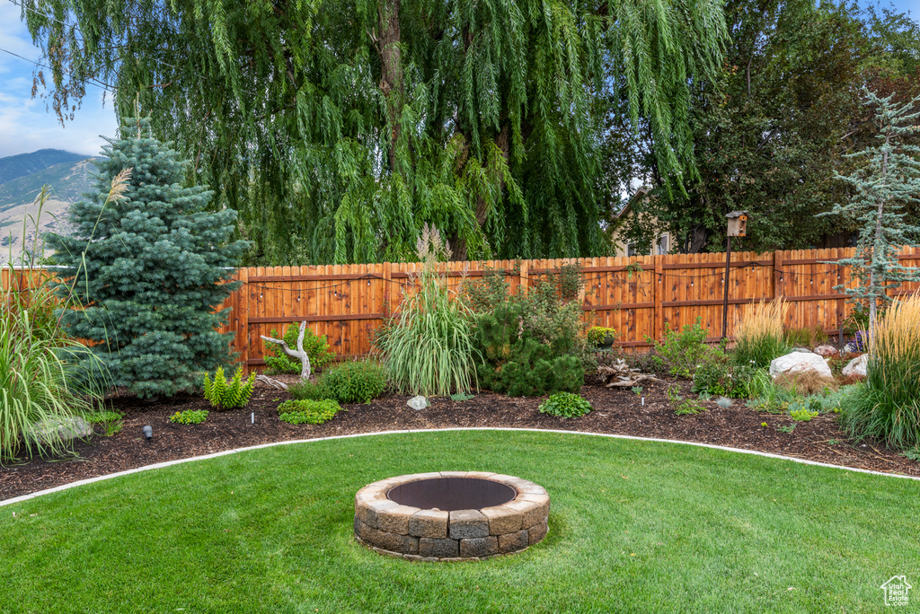 View of yard with a fire pit and a mountain view