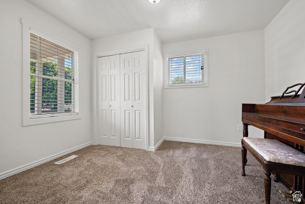 Bedroom featuring carpet floors and a closet