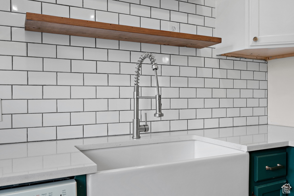 Bathroom with a sink and decorative backsplash