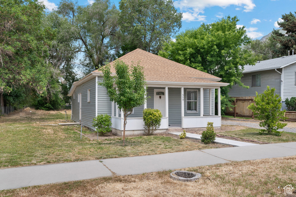 Bungalow-style home featuring covered porch and a shingled roof