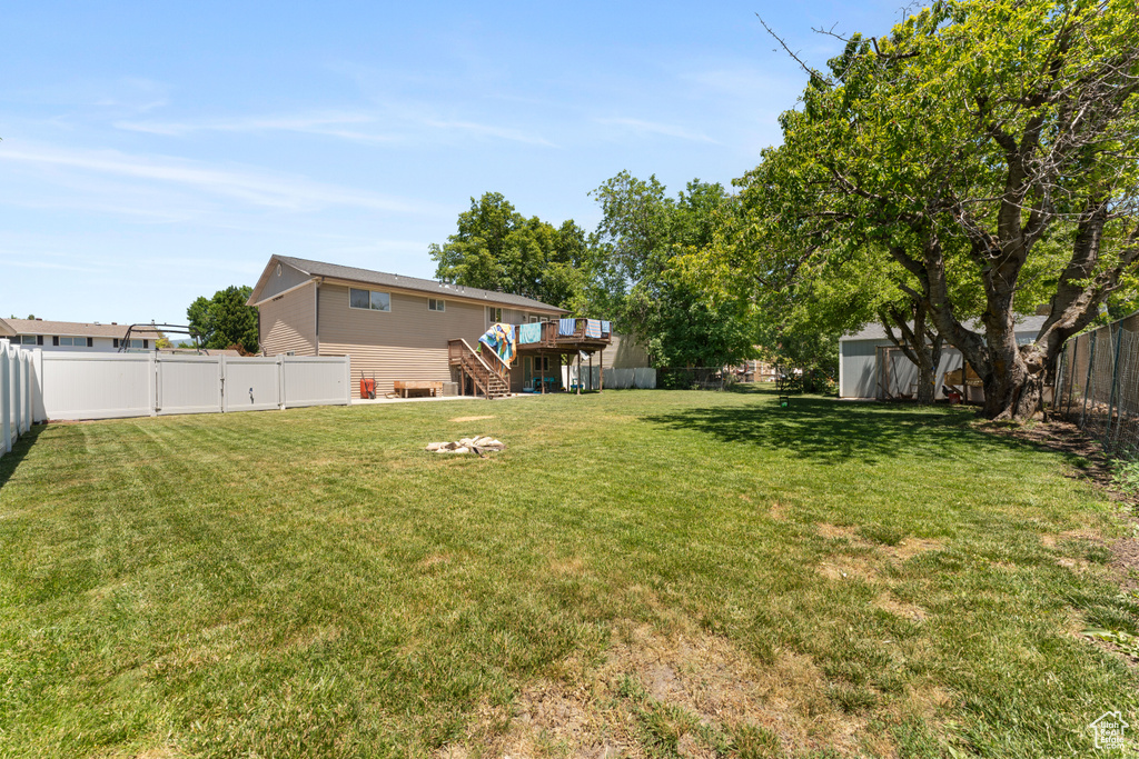 View of yard with stairway and a wooden deck