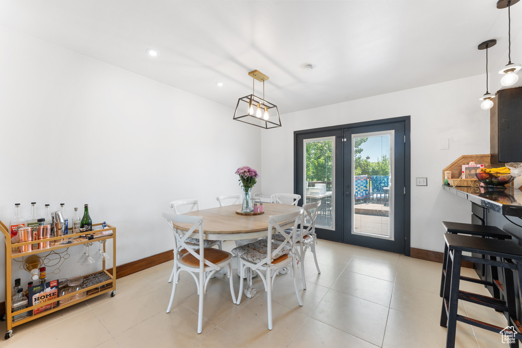 Dining room featuring french doors, baseboards, light tile patterned floors, and recessed lighting