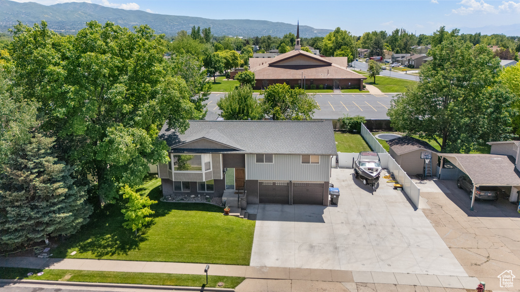 Aerial view of property and surrounding area with a mountain backdrop