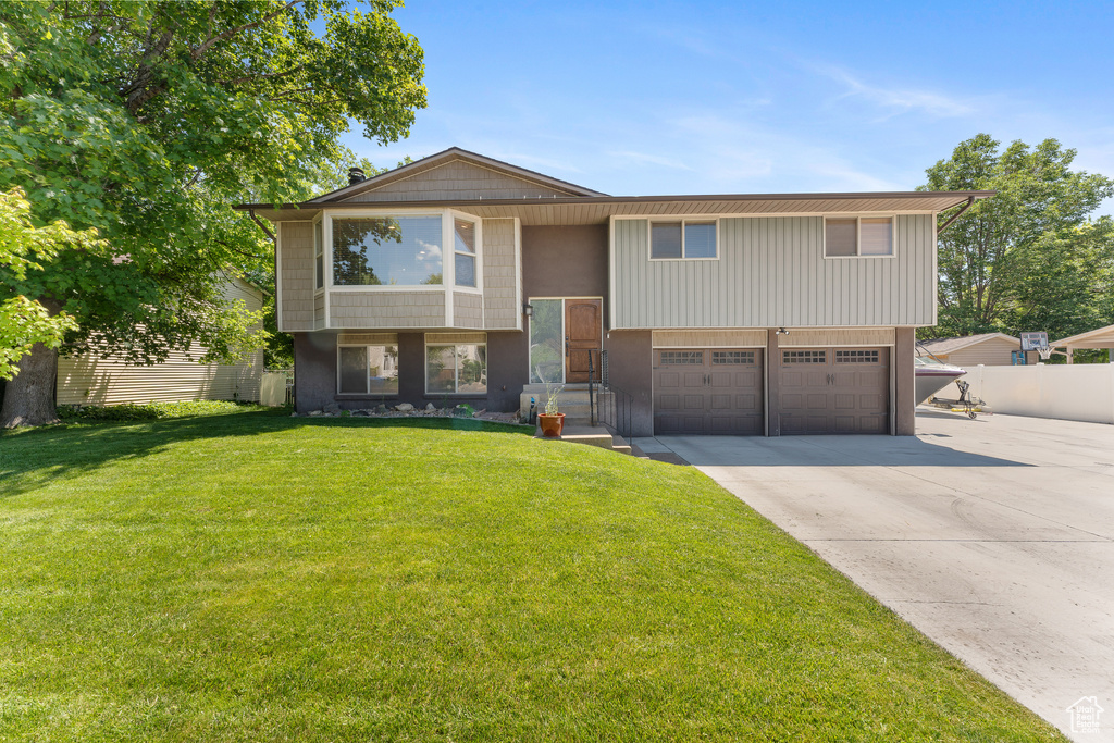 Split foyer home featuring a garage and driveway