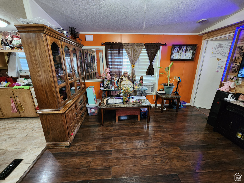 Living room with a textured ceiling and hardwood / wood-style floors