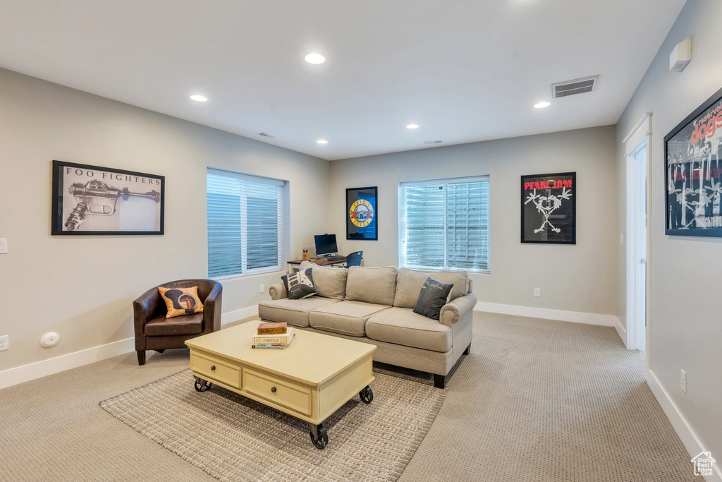 Living room with light carpet and recessed lighting