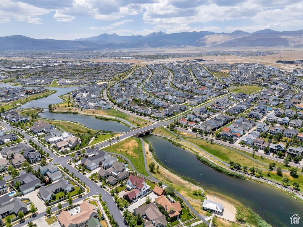 Aerial view of property's location featuring a water and mountain view and nearby suburban area