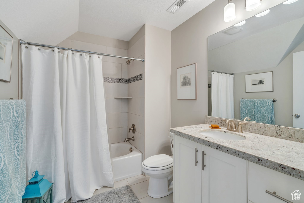 Full bath featuring vanity, tile patterned flooring, and shower / bath combo