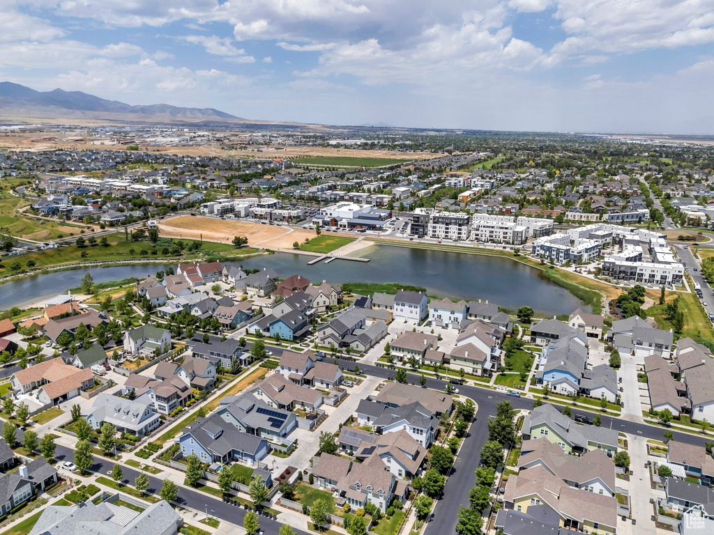 Aerial overview of property's location featuring a water and mountain view and nearby suburban area