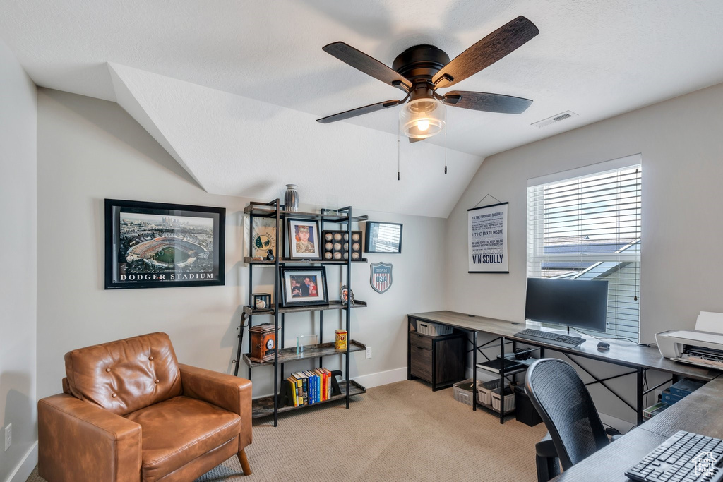 Office space with a ceiling fan, lofted ceiling, and light colored carpet