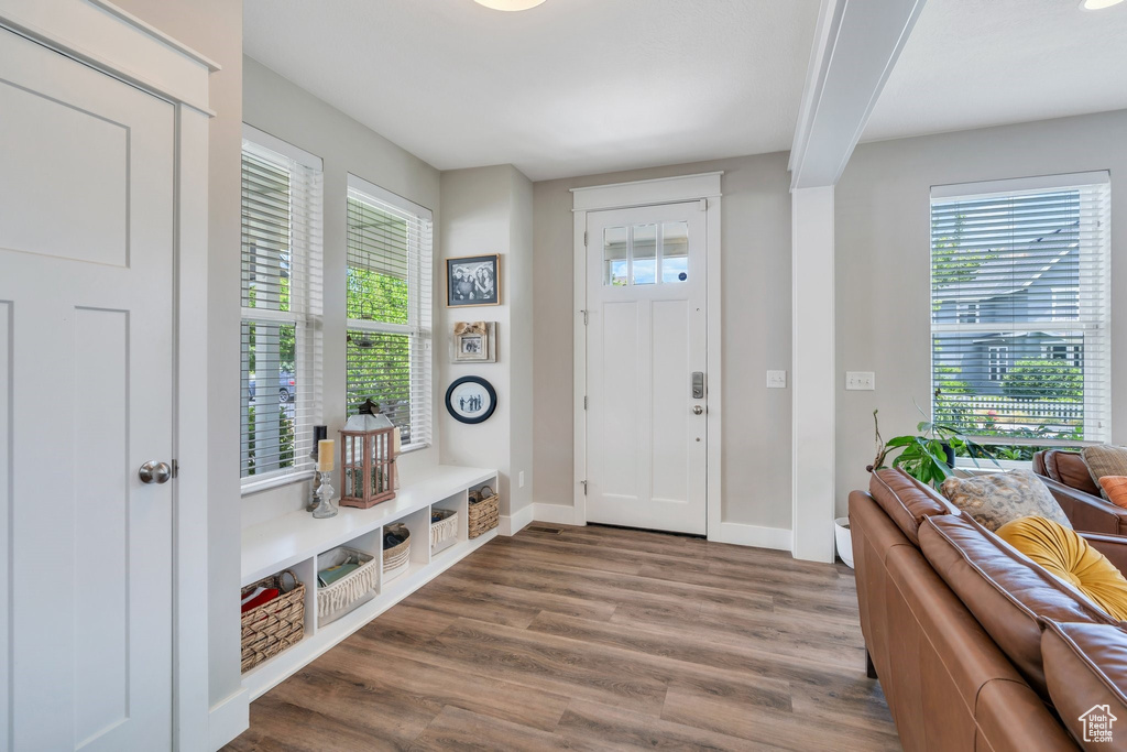 Foyer entrance with wood finished floors and baseboards