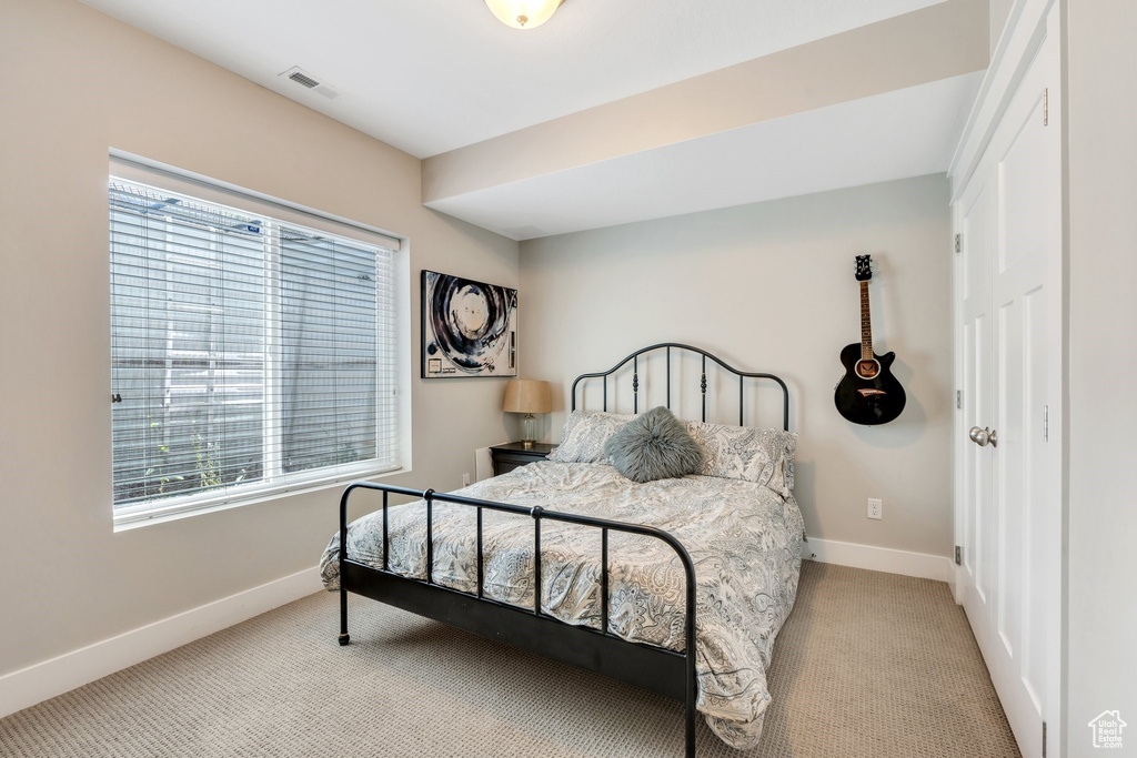Carpeted bedroom featuring baseboards