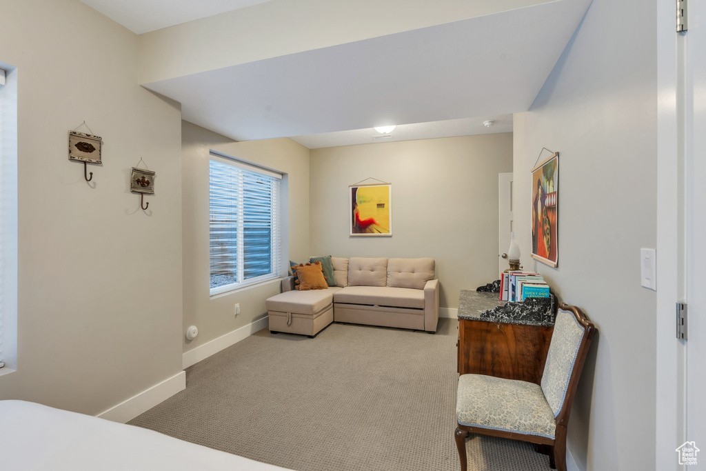 Carpeted living area featuring baseboards